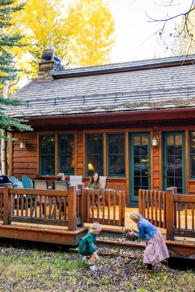 Kids playing in the fall leaves at an Aspens rental property in Jackson Hole